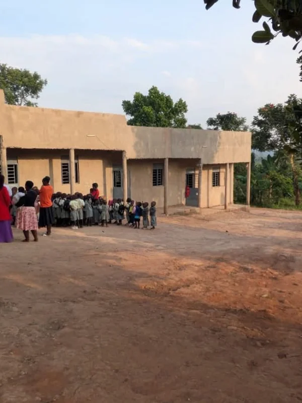 Pupils gathered outside the Ubuntu Academy classroom block in the late afternoon